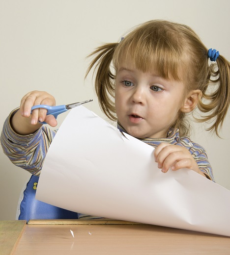 Child developing fine motor skills through supervised activities